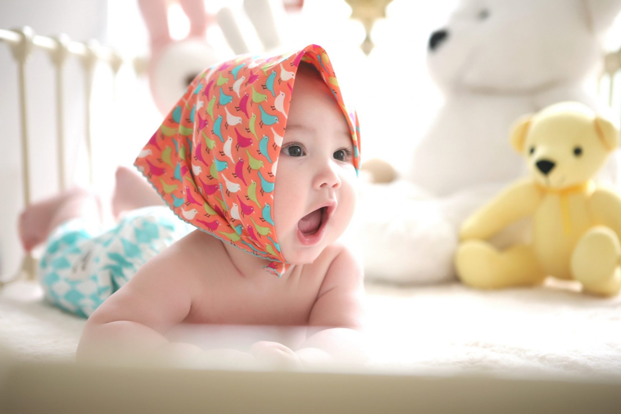 A baby wearing a cute head scarf